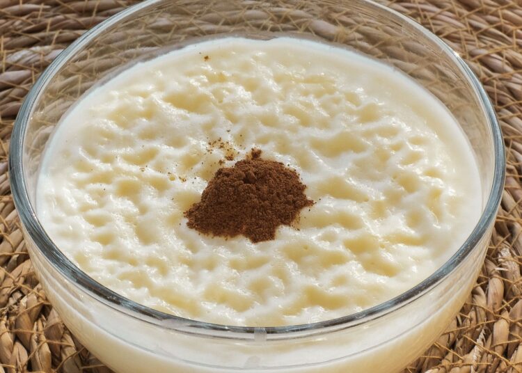 Cuenco de arroz con leche saludable cremoso espolvoreado con canela molida