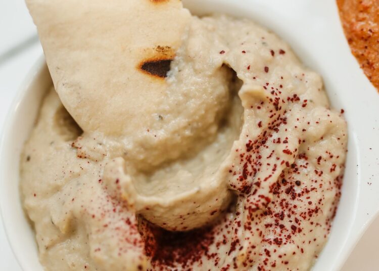 Baba ganoush casero servido en un cuenco con aceite de oliva y pan de pita para mojar